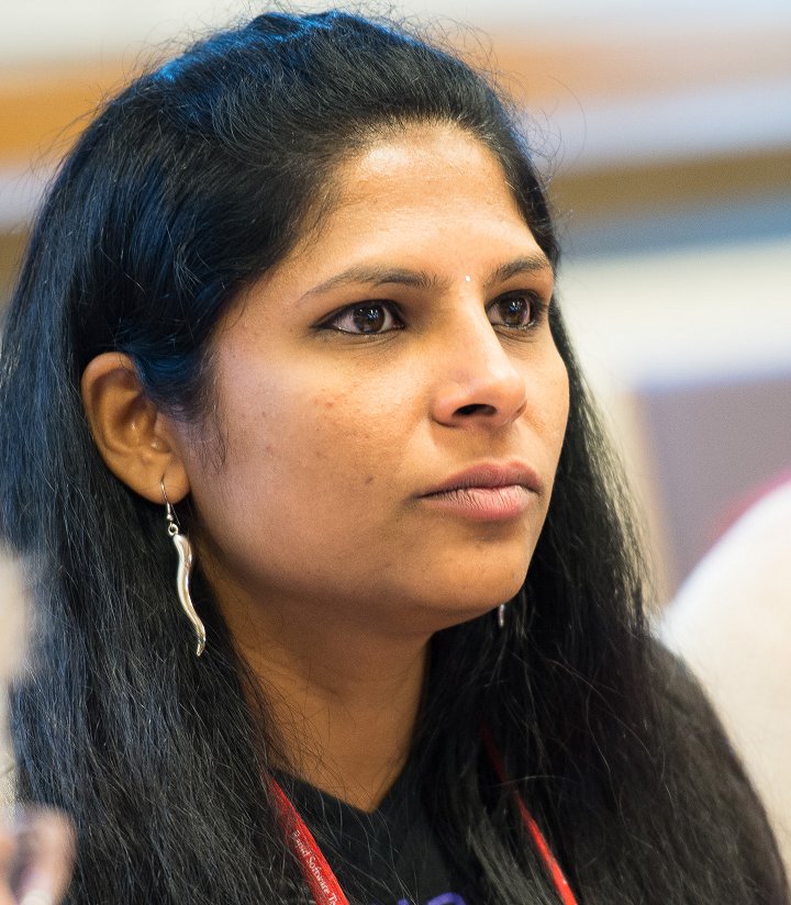 Close-up of Parimala Hariprasad listening attentively at a professional event