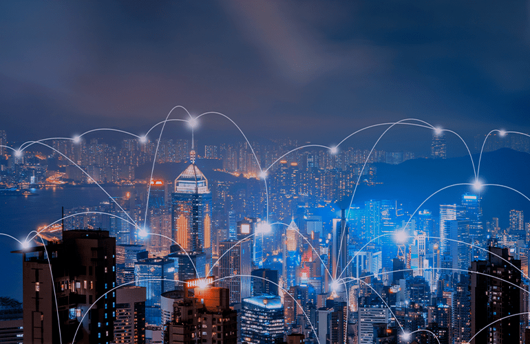 City skyline at night with glowing network connections illustrating scalable digital infrastructure