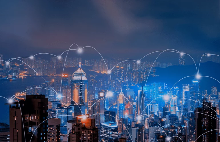 City skyline at night with glowing network connections illustrating scalable digital infrastructure