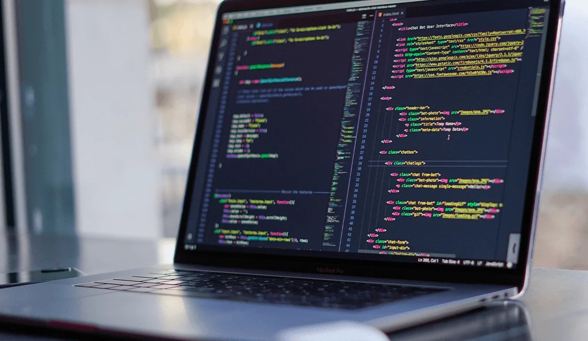 Laptop displaying source code for web application testing and development