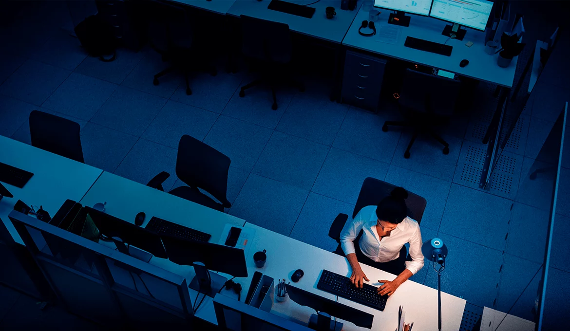 Overhead view of QA engineer working at desk in a modern office