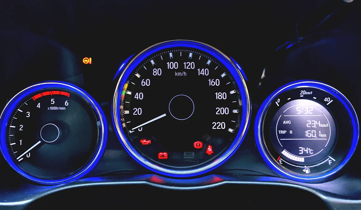 Car dashboard interface with illuminated gauges, digital display, and warning indicators for usability testing