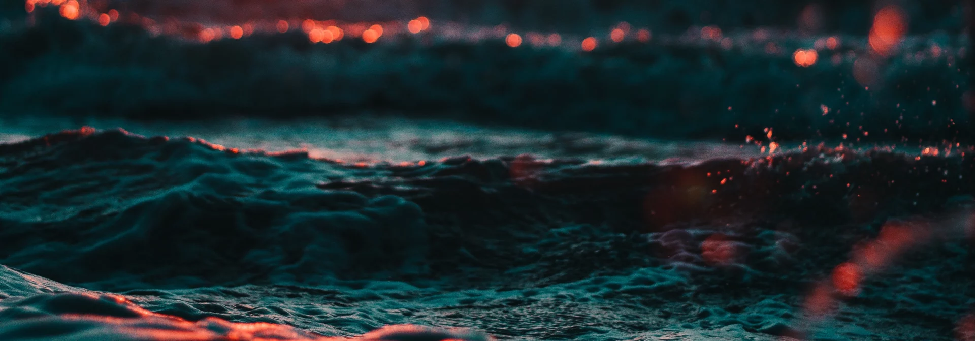 Abstract close-up of dark waves with glowing highlights, representing live production environment