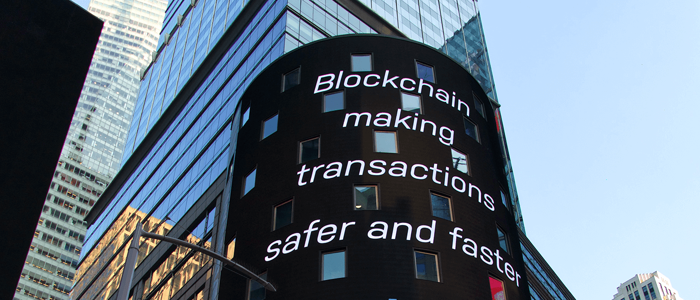 Skyscraper display reading Blockchain making transactions safer and faster