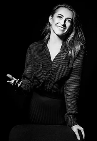 Smiling QA team member gesturing during a conversation in a professional portrait