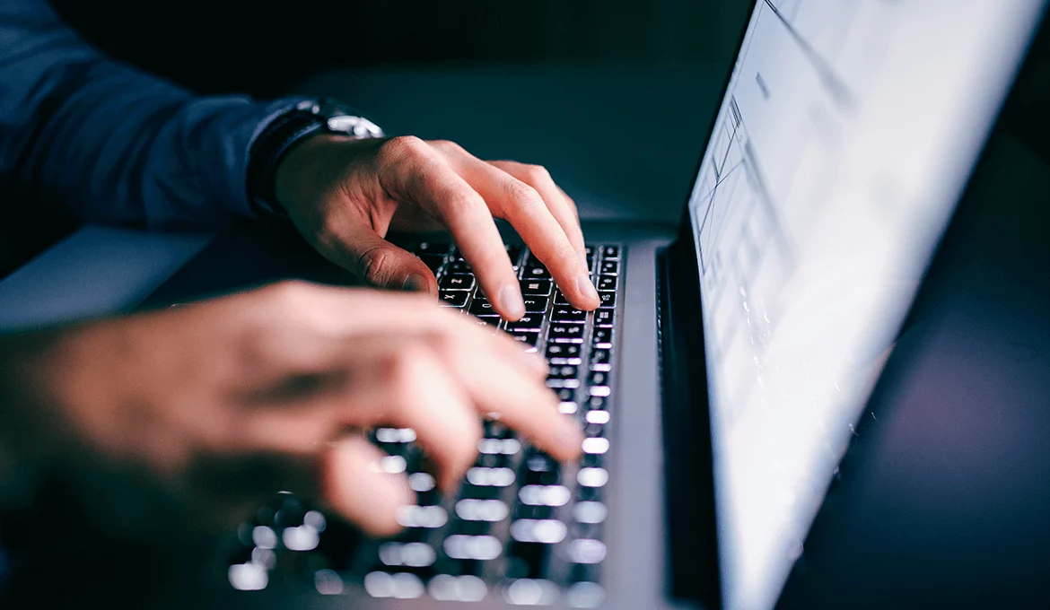 Hands typing on a laptop, representing web application test automation work