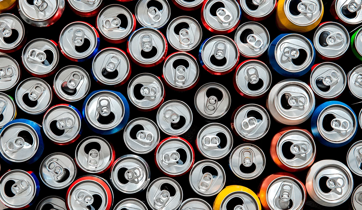 Assorted aluminum beverage cans viewed from above, representing volume and variety