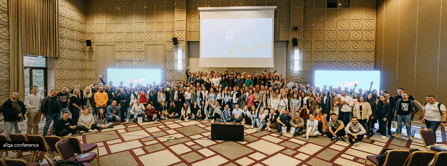 Large group photo at a1qa conference in a hotel event hall