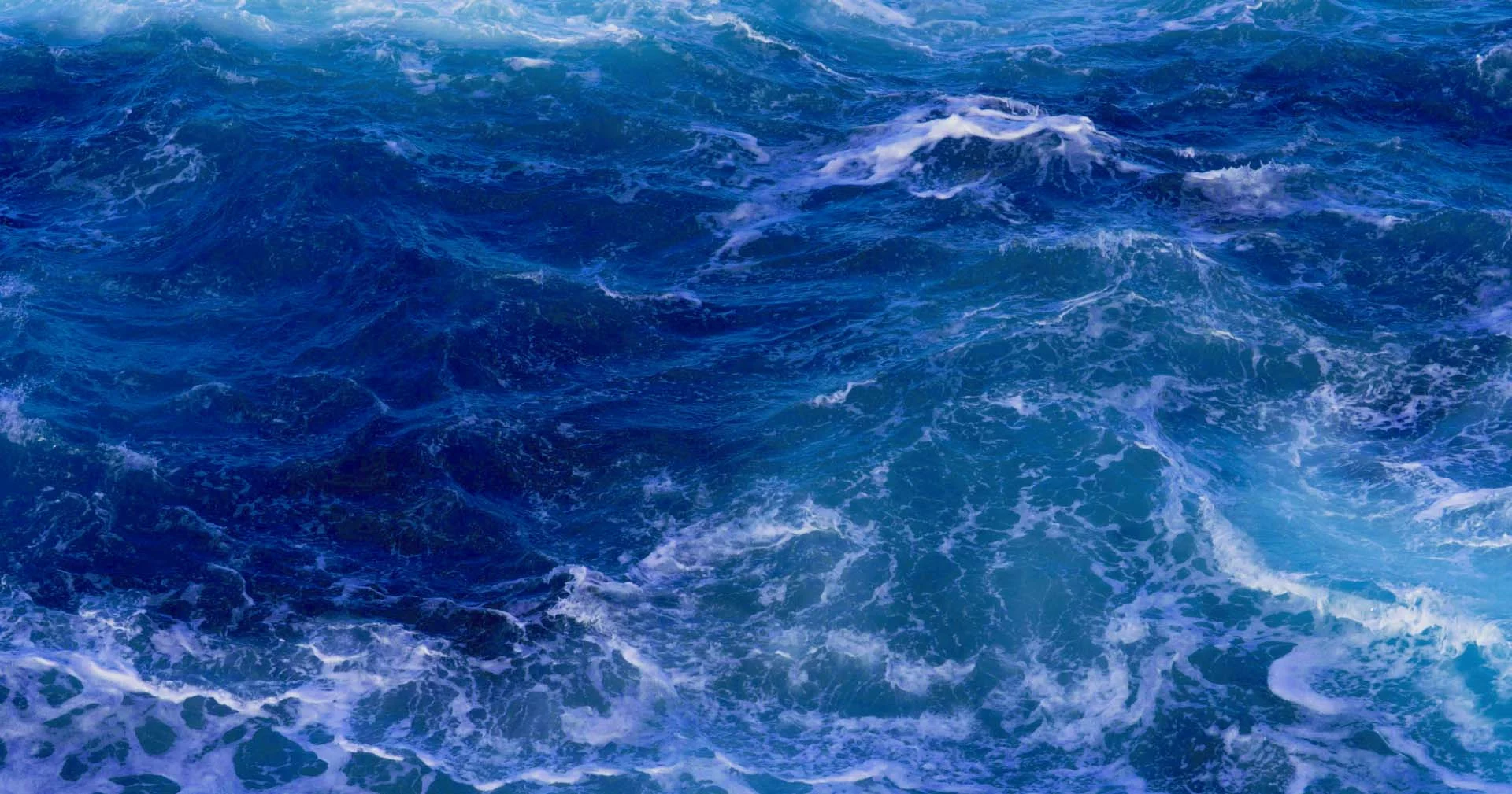Churning blue ocean waves symbolizing complexity and untapped potential in stalled AI initiatives